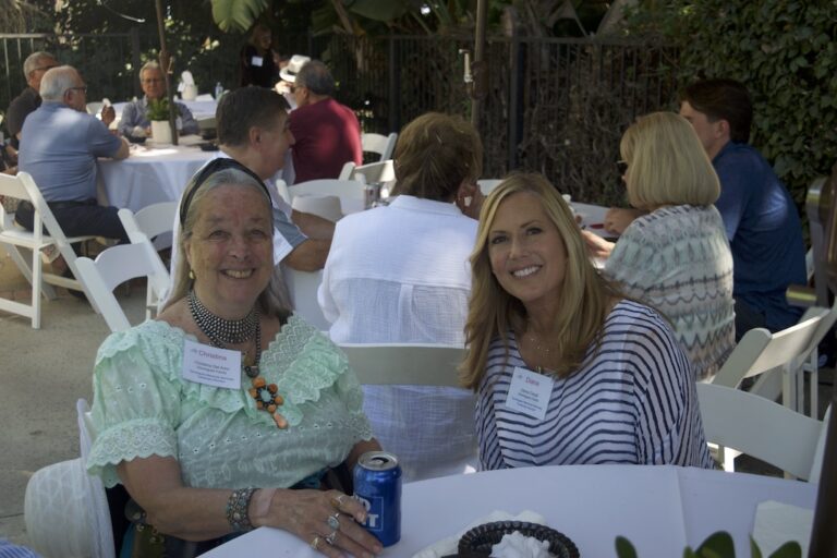 2 women sitting at table